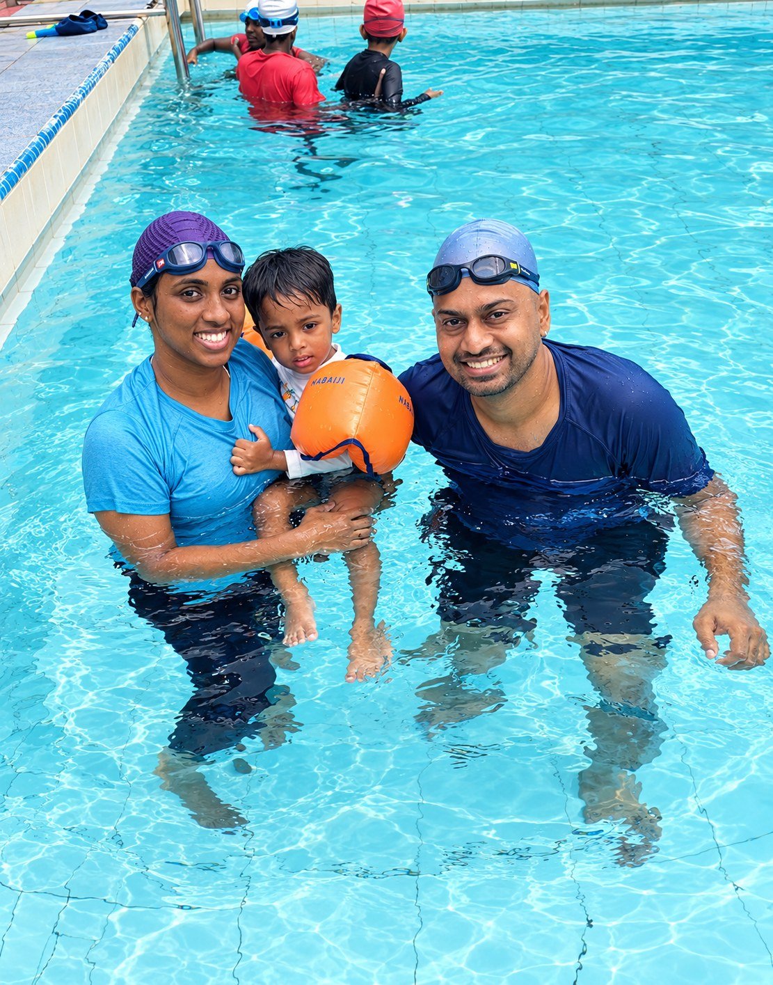 Family supporting a child during a swimming session